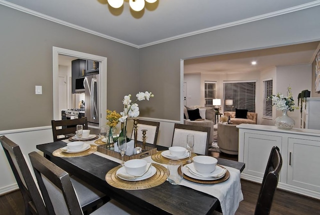 dining room featuring ornamental molding and dark hardwood / wood-style flooring