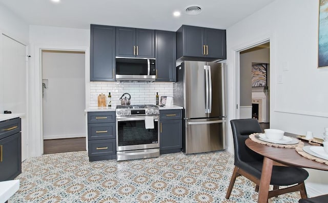 kitchen with appliances with stainless steel finishes and tasteful backsplash