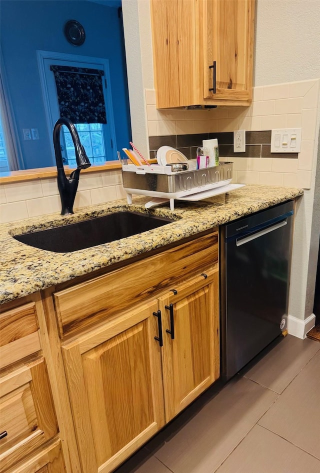 kitchen featuring light tile patterned floors, black dishwasher, backsplash, and sink