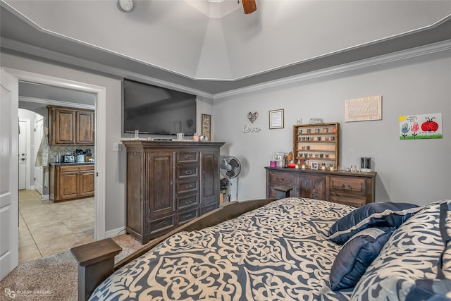 tiled bedroom featuring ceiling fan, crown molding, and a raised ceiling