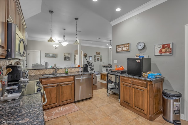 kitchen with light tile patterned floors, ceiling fan, appliances with stainless steel finishes, decorative light fixtures, and sink