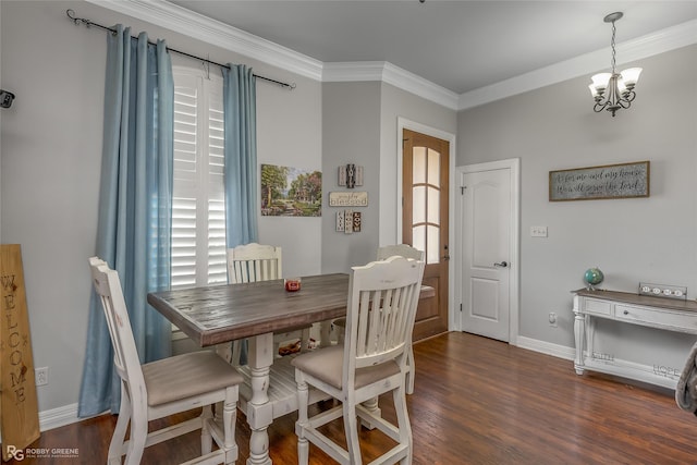 dining area with a chandelier, ornamental molding, and dark hardwood / wood-style floors