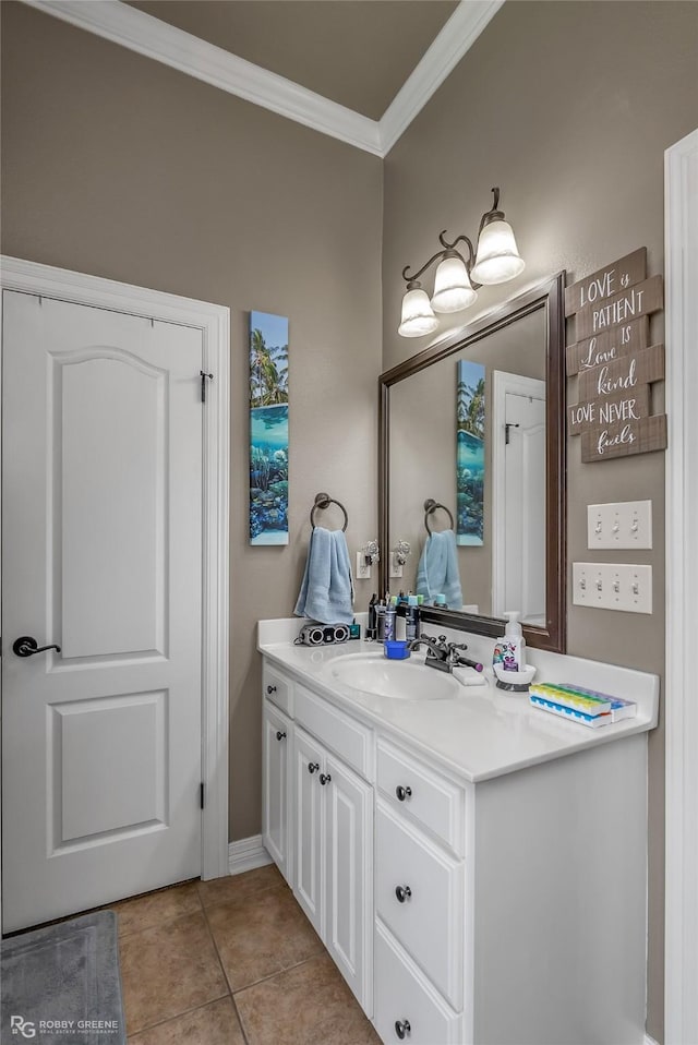 bathroom featuring tile patterned flooring, ornamental molding, and vanity