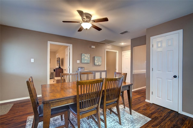 dining space featuring ceiling fan and dark hardwood / wood-style flooring