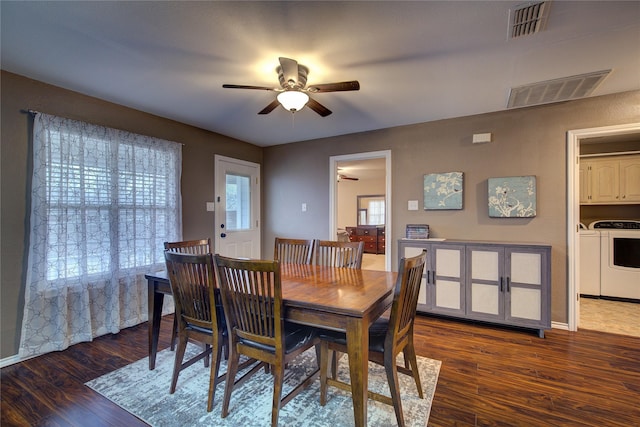 dining area with ceiling fan, separate washer and dryer, and dark hardwood / wood-style floors