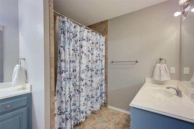 bathroom featuring vanity and curtained shower