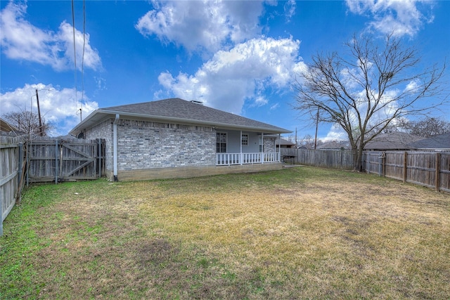 rear view of house with a lawn