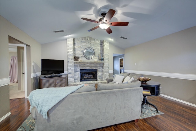 living room featuring ceiling fan, dark wood-type flooring, lofted ceiling, and a fireplace