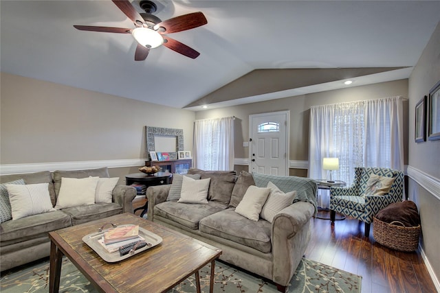 living room featuring ceiling fan, a wealth of natural light, dark hardwood / wood-style floors, and lofted ceiling