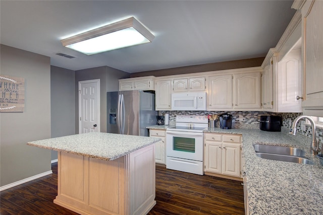 kitchen featuring white appliances, a kitchen island, decorative backsplash, sink, and dark hardwood / wood-style floors