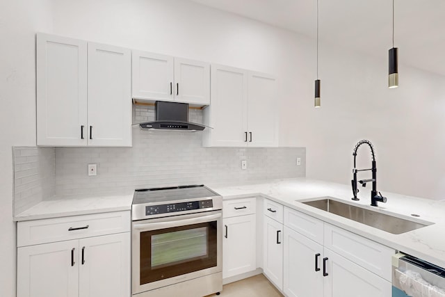 kitchen with decorative light fixtures, sink, stainless steel appliances, white cabinets, and wall chimney exhaust hood