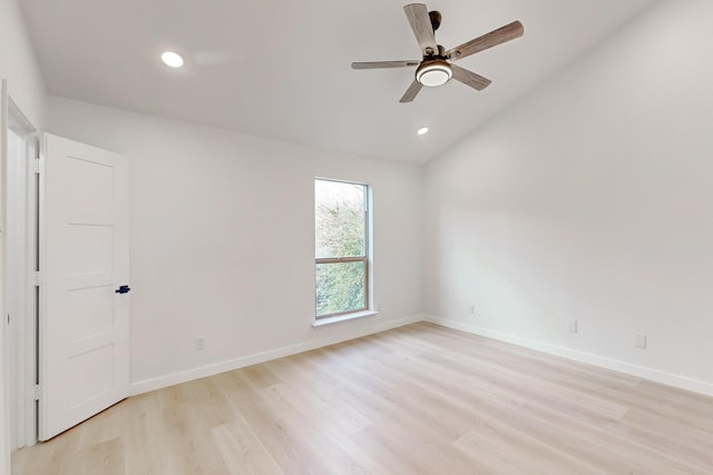 spare room with vaulted ceiling, ceiling fan, and light hardwood / wood-style floors