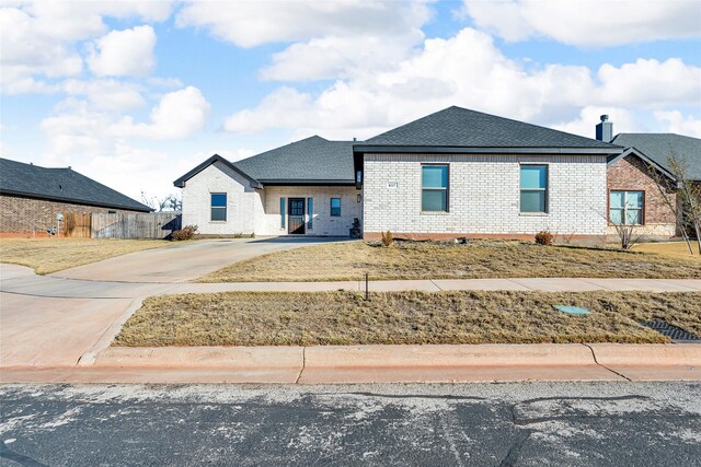 view of front of property with a front yard and a garage