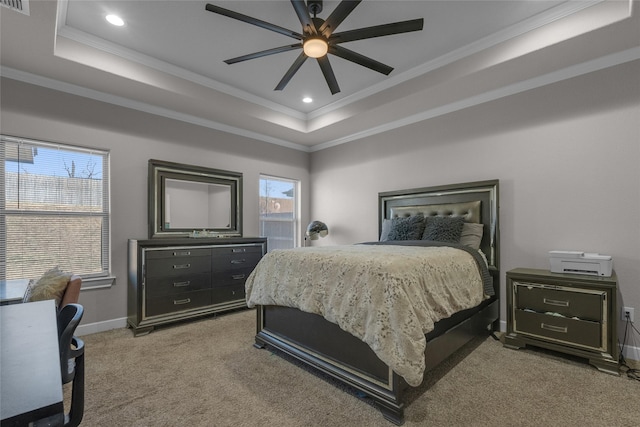 carpeted bedroom with multiple windows, a raised ceiling, and ceiling fan