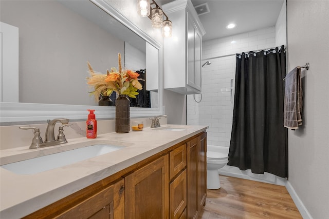 bathroom featuring a shower with curtain, vanity, hardwood / wood-style floors, and toilet