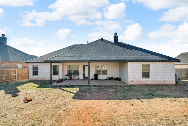 back of property featuring a yard and a patio