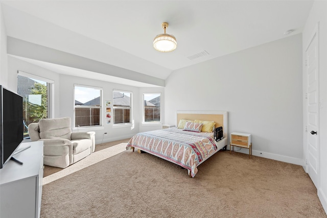 bedroom with vaulted ceiling and carpet floors