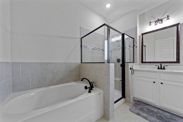 bathroom featuring tile patterned floors, vanity, and shower with separate bathtub