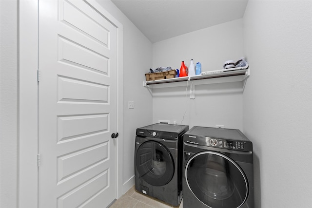 laundry room with light tile patterned floors and washer and dryer