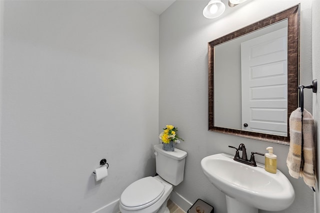 bathroom featuring toilet and sink