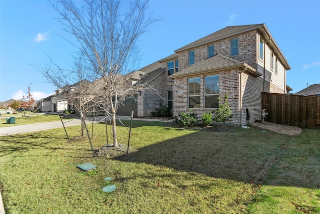 rear view of house featuring a lawn