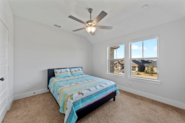 carpeted bedroom with ceiling fan and lofted ceiling