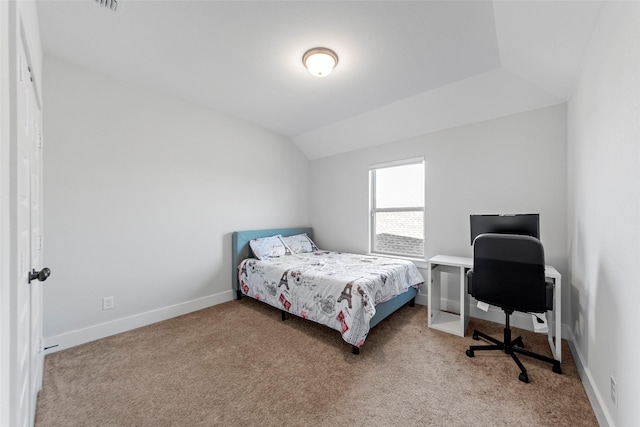 carpeted bedroom with lofted ceiling