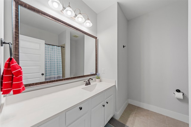 bathroom featuring tile patterned floors, vanity, and curtained shower