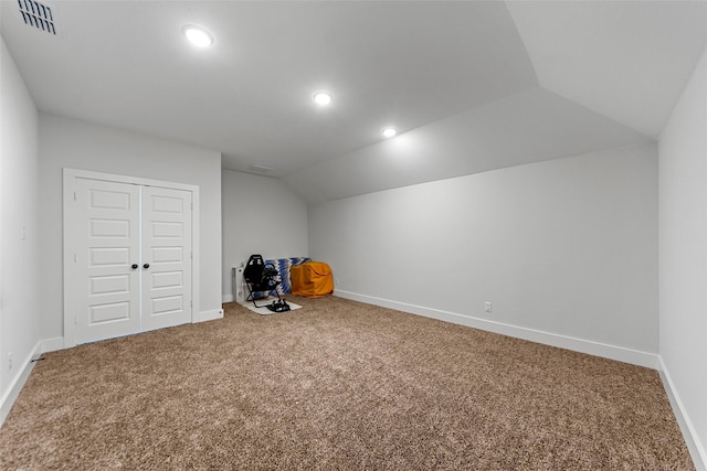 additional living space featuring carpet and lofted ceiling