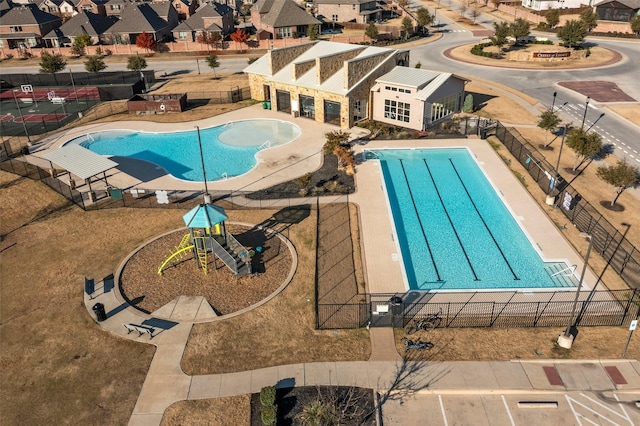 view of swimming pool featuring a playground and a patio area