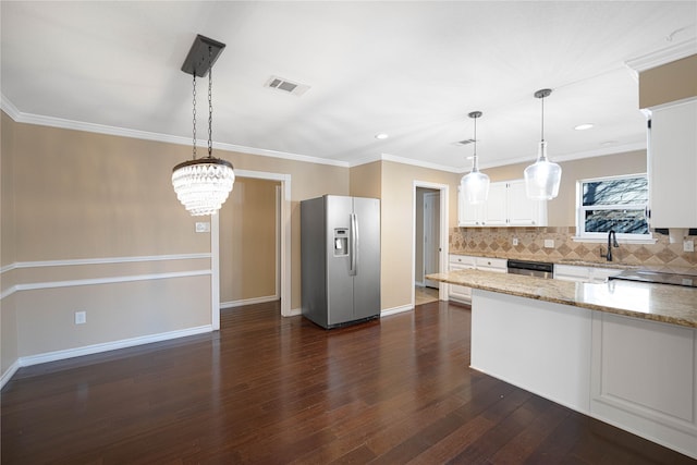 kitchen featuring white cabinetry, appliances with stainless steel finishes, light stone counters, and pendant lighting