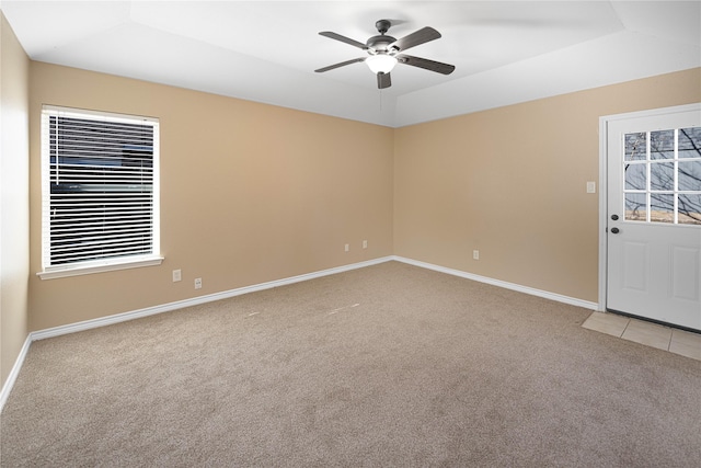 unfurnished room featuring vaulted ceiling, light colored carpet, and ceiling fan