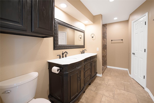 bathroom with tile patterned flooring, vanity, and toilet