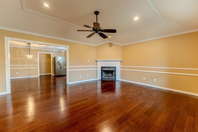 unfurnished living room with vaulted ceiling, ornamental molding, ceiling fan with notable chandelier, and dark hardwood / wood-style floors