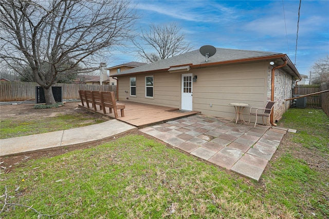 back of house with a lawn and a deck