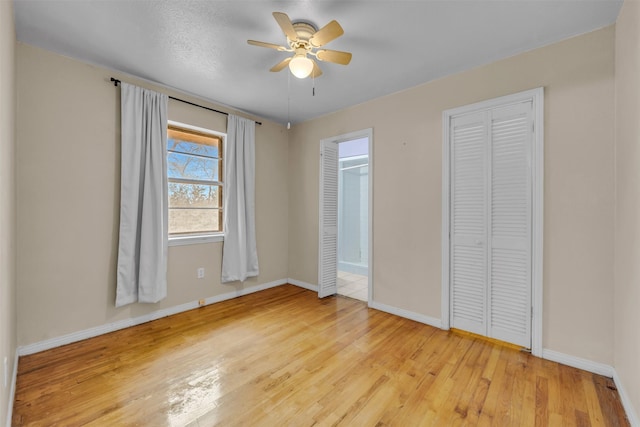 unfurnished bedroom featuring light wood-type flooring and ceiling fan