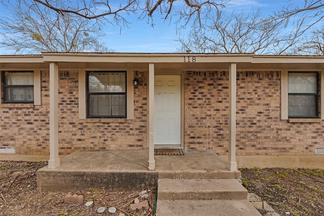 doorway to property featuring covered porch