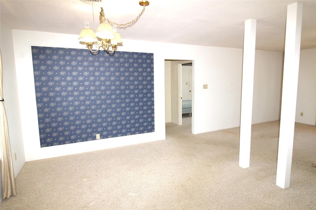 unfurnished room featuring light colored carpet and a chandelier