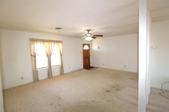 empty room with light colored carpet and ceiling fan