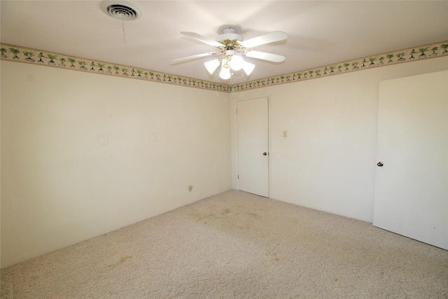 carpeted empty room with ceiling fan