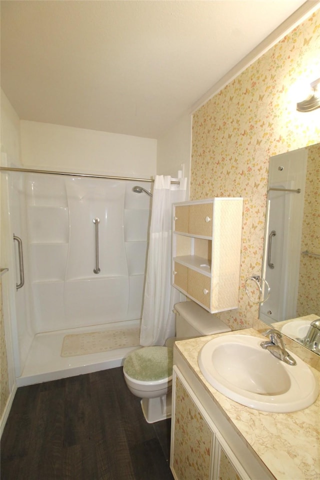 bathroom featuring vanity, hardwood / wood-style flooring, toilet, and a shower with shower curtain