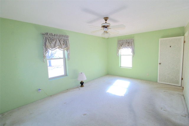 carpeted empty room with ceiling fan