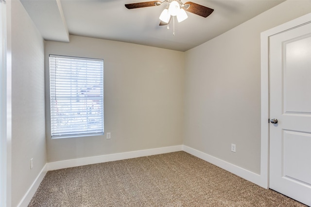 carpeted spare room with ceiling fan