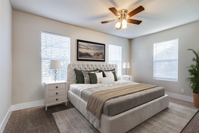 bedroom featuring ceiling fan and dark colored carpet