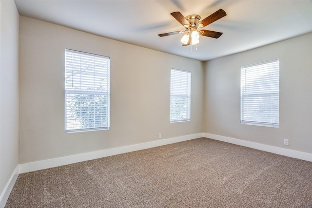 unfurnished room with carpet floors, plenty of natural light, and ceiling fan