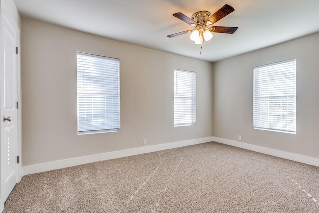 empty room featuring carpet floors and ceiling fan