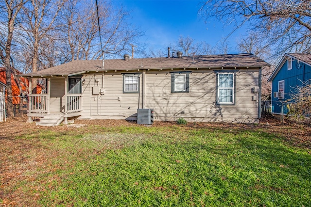 back of property featuring cooling unit and a yard