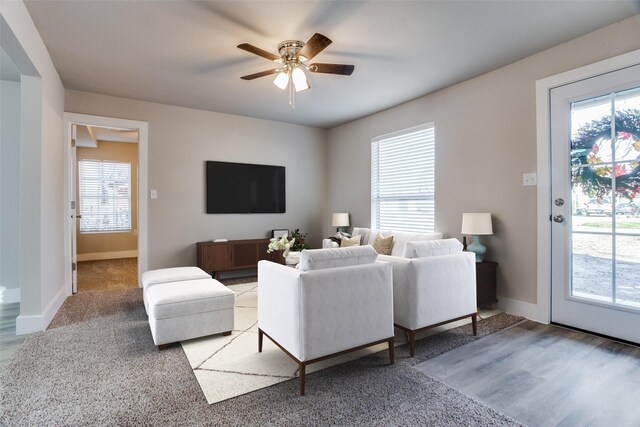 empty room featuring ceiling fan, plenty of natural light, and carpet flooring