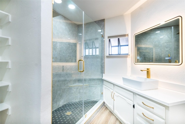 bathroom with vanity, hardwood / wood-style floors, and walk in shower