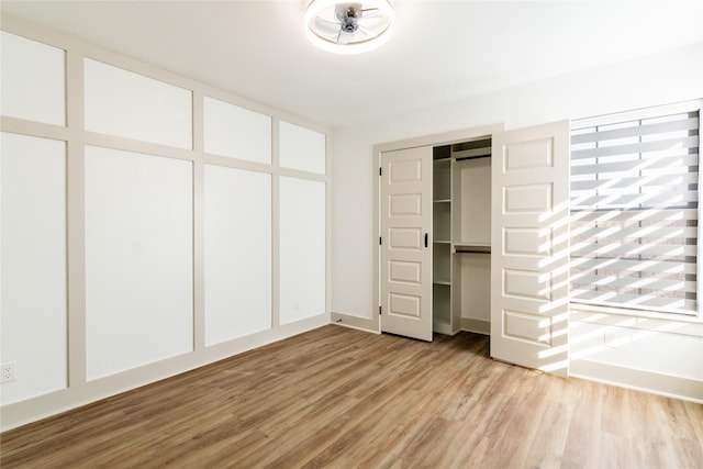 unfurnished bedroom featuring light wood-type flooring and a closet